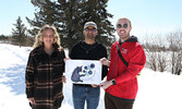 From left: Blueberry Festival Co-Chair Alanna Pizziol-Carroll, Blueberry Festival Coordinator Aayush Vispute, and Blueberry Festival Co-Chair Reece Van Breda unveil the 2026 Blueberry Festival logo, designed by Storm Angeconeb.     Tim Brody / Bulletin Ph