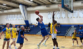 Steve Laidlaw makes a move for the basket while Troy Henry defends in a memorial basketball tournament this past weekend in Dryden to celebrate the life of Chuck Schmitt. Submitted Photo