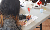 Kids participated in various activities, including colouring, during Family Dental Day at the Nishnawbe-Gamik Friendship Centre. - Jesse Bonello / Bulletin Photo