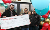 Pastor Carter Krahn (left) accepts a donation from Your Dollar Store With More on behalf of The Sioux Lookout Food Bank.   Tim Brody / Bulletin Photo