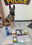 K-9 “Kona” of the Lac Seul Police Service with items seized by police after initiating a traffic stop on Oct. 22 in Lac Seul First Nation.     Submitted Photo