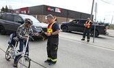 Sioux Lookout Fire Service member Al Howie accepts a donation from a passing cyclist.    Tim Brody / Bulletin Photo
