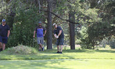 Justin McClure takes a chip shot at the pin on Hole 4.     Tim Brody / Bulletin Photo