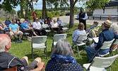 Sacred Heart Church representative Father Stephen Chilaka speaks to those gathered for the Inter-Church Song and Prayer Service.   Tim Brody / Bulletin Photo