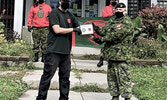 Junior Canadian Ranger Michael Baxter, left, receives a cheque for $1,000 to further his education and a plaque from 2nd Lieutenant Jack Teskey of the Canadian Army. - Photo Courtesy Corporal David M. Thompson