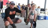 Three-year-old Grady Gerula and his dad Jesse Gerula show off their 3.35 pound walleye, held by tournament volunteer Jeremy Funk.    Tim Brody / Bulletin Photo 