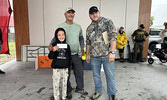 Taking first place in the Under 12 category was the team of Fisher Stevenson (left) and Bryan Thompson (centre) with a total catch weight of 7.66 pounds. Presenting them with their prize is Tournament Director Jeremy Funk. Tim Brody / Bulletin Photo
