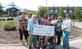 Front from left: Margaret Angeconeb (wife of the late Garnet Angeconeb) and Mahkwa Lodge representative Derek Maud. Back from left: Teresa Angeconeb (holding nephew Garnet Angeconeb), SLMHC Foundation President Christine Hoey, Mahkwa Lodge representative 