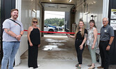 McFee’s Car Wash celebrated its grand opening on July 31. Cutting a ribbon to officially open the business is McFee’s Car Wash owner Savannah McFee (centre). Joining McFee for the celebration were Municipal Councilors Reece Van Breda (far left) and Joan C