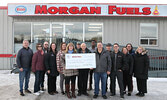 Darrell Morgan (6th from right) is joined by father Lew Morgan (on his right), son Max Morgan (on his left), as well as members of his staff as he makes a donation, on behalf of the Morgan family, to help make Sioux Lookout’s MRI unit a reality. Accepting