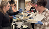 Members of Sioux Lookout’s VAAC Committee prepare plates of holiday dinner for community members.    Tim Brody / Bulletin Photo