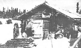 John Albrecht outside the cabin he shared with Nan at the south end of Selwyn Lake, SK.     Source: Dr. Klaus Lehnert-Thiel