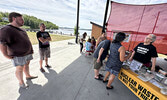 Visitors to We the Nuclear Free North’s booth at the town beach on August 5. The organization plans to make stops in several other communities in Northwestern Ontario this month.   Tim Brody / Bulletin Photo 