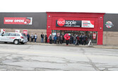 After waiting for the doors to the Red Apple store to open, customers explored the store’s selection of products as they shopped. A ribbon-cutting ceremony preceded the opening of the store.     Tim Brody / Bulletin Photo