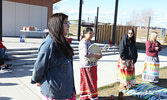 Usinece Robinson, SWAC Housing Support Worker (foreground left), addresses visitors to the Town Beach following singing and drumming by Romaine Lyon (second from left).     Tim Brody / Bulletin Photo