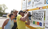 From left: Rotarians Alanna Pizziol-Carroll, Bill Hochstedler, and Lorenzo Durante add the final community club panel to the new sign across from the town beach promoting local clubs and organizations.   Tim Brody / Bulletin Photo 