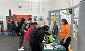 Students visit the booths of local businesses and organizations to find out about potential career opportunities.    Tim Brody / Bulletin Photo