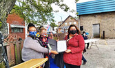 Gina Rae (right) receives her certificate of graduation for the Youth Pre-Employment Training Program.  - Reeti Meenakshi Rohilla / Bulletin Photo