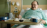 A smiling SLMHC patient served with a tray of Miichim (traditional food).       Sioux Lookout Meno Ya Win Health Centre / Submitted Photo