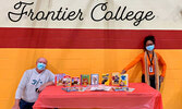 SMPS Principal Wayne Mercer (left) and vice-principal Barbara van Diest (right) with the books gifted by Frontier College to school students.    Kristen Prouse / Submitted Photo