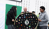 SNHS Principal Wayne Mercer (centre) accepts a beaded art piece for the school, Mamow Gawiitanokiimitemin / Let’s Work Together, from Mariah Anderson-Mekanak (left) and Myzel Derouin (right). - Tim Brody / Bulletin Photo