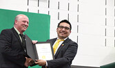 Mercer (left) accepts a congratulatory certificate for the school from Kiiwetinoong MPP Sol Mamakwa. - Tim Brody / Bulletin Photo