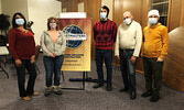 Attendees at the Siouxper Speakers Toastmasters’ Christmas meeting pose next to their Toastmasters International’ Charter.  - Reeti Meenakshi Rohilla/Bulletin Photo