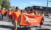 Participants in this year’s Walk for Truth and Reconciliation, organized by Sioux Lookout First Nations Health Authority, make their way down Front Street to the town beach.     Tim Brody / Bulletin Photo