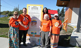 Members of the Municipality of Sioux Lookout’s Truth and Reconciliation Committee pose for a photo with one of the new banners the committee spearheaded the creation of, which were unveiled at the town beach during SLFNHA’s Walk for Truth and Reconciliati