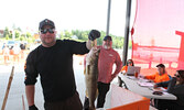 Tournament Coordinator Jeremy Funk holds up Rooke Pitura’s (standing behind) big fish of the day, which weighed in at 5.37 pounds.   Tim Brody / Bulletin Photo