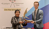 The Hon. Sam Oosterhoff, Associate Minister of Energy-Intensive Industries, presents a gift to Margaret Kenequanash.     Photo courtesy of Dan Garrity Media